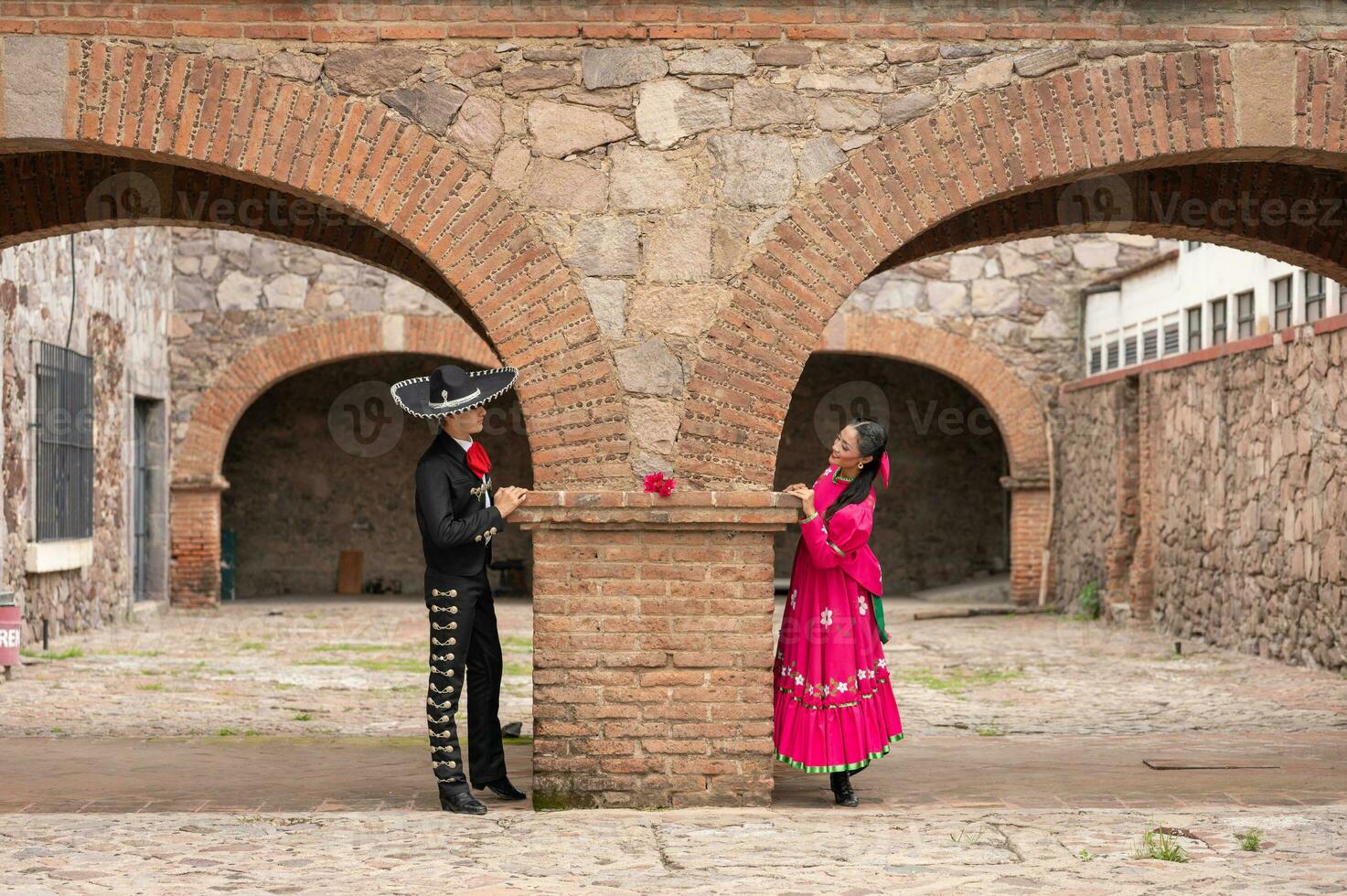 young hispanic woman and man in independence day or cinco de mayo parade or cultural Festival photo