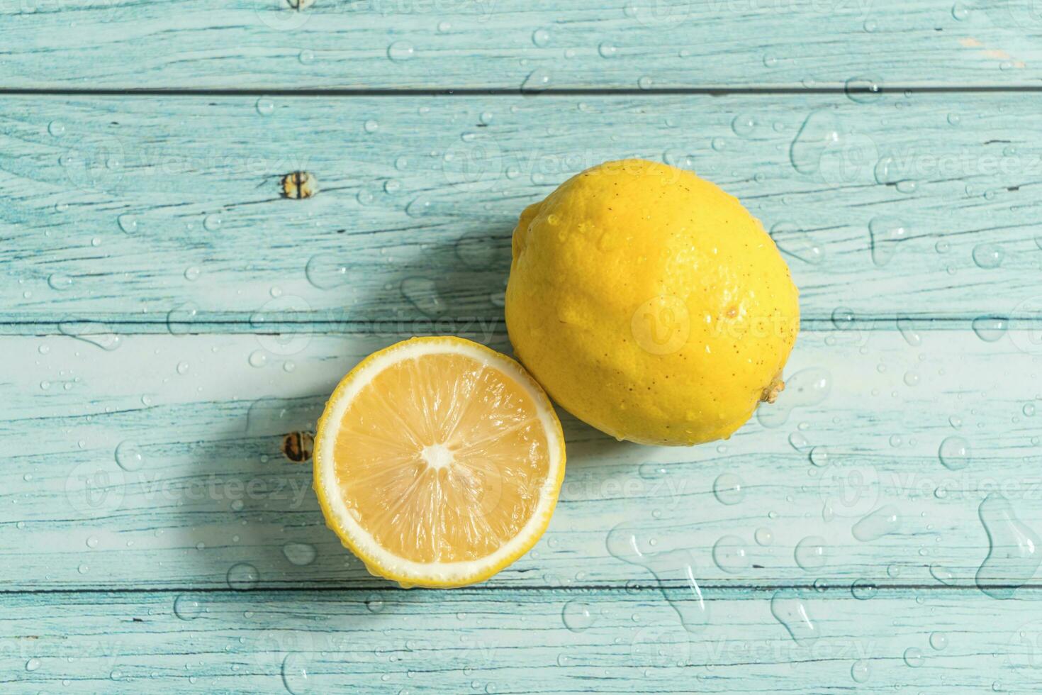 the fruit lemon on the blue table, cool light background photo