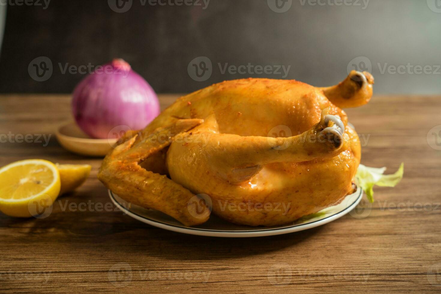 Roast chicken on the wooden table photo