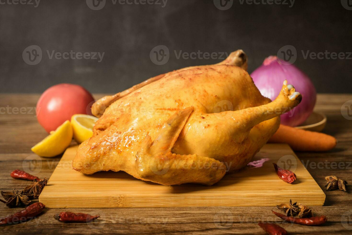 Roast chicken on the wooden table photo