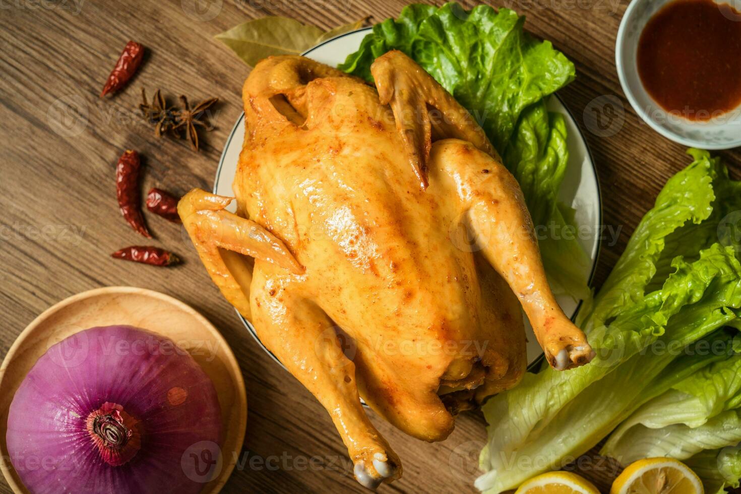 Roast chicken on the wooden table photo