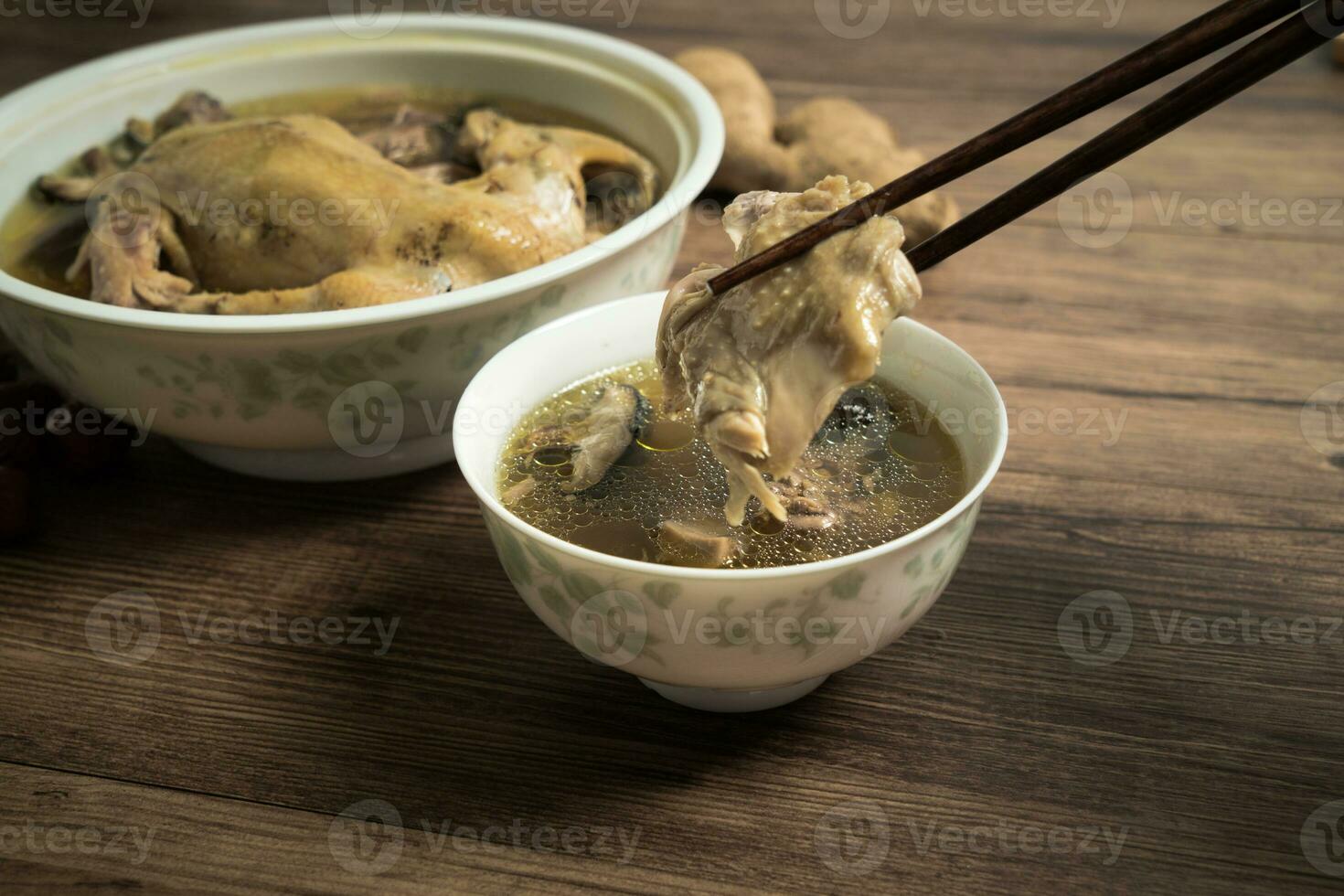 Chicken soup and wooden background. photo