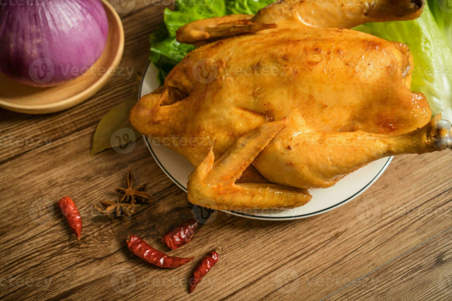 Roast chicken on the wooden table photo