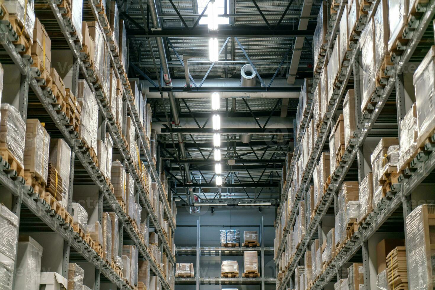 The warehouse full of goods, boxes and shelves photo