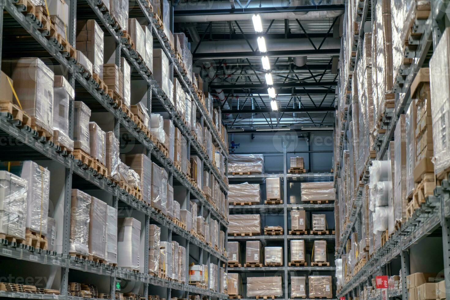 The warehouse full of goods, boxes and shelves photo