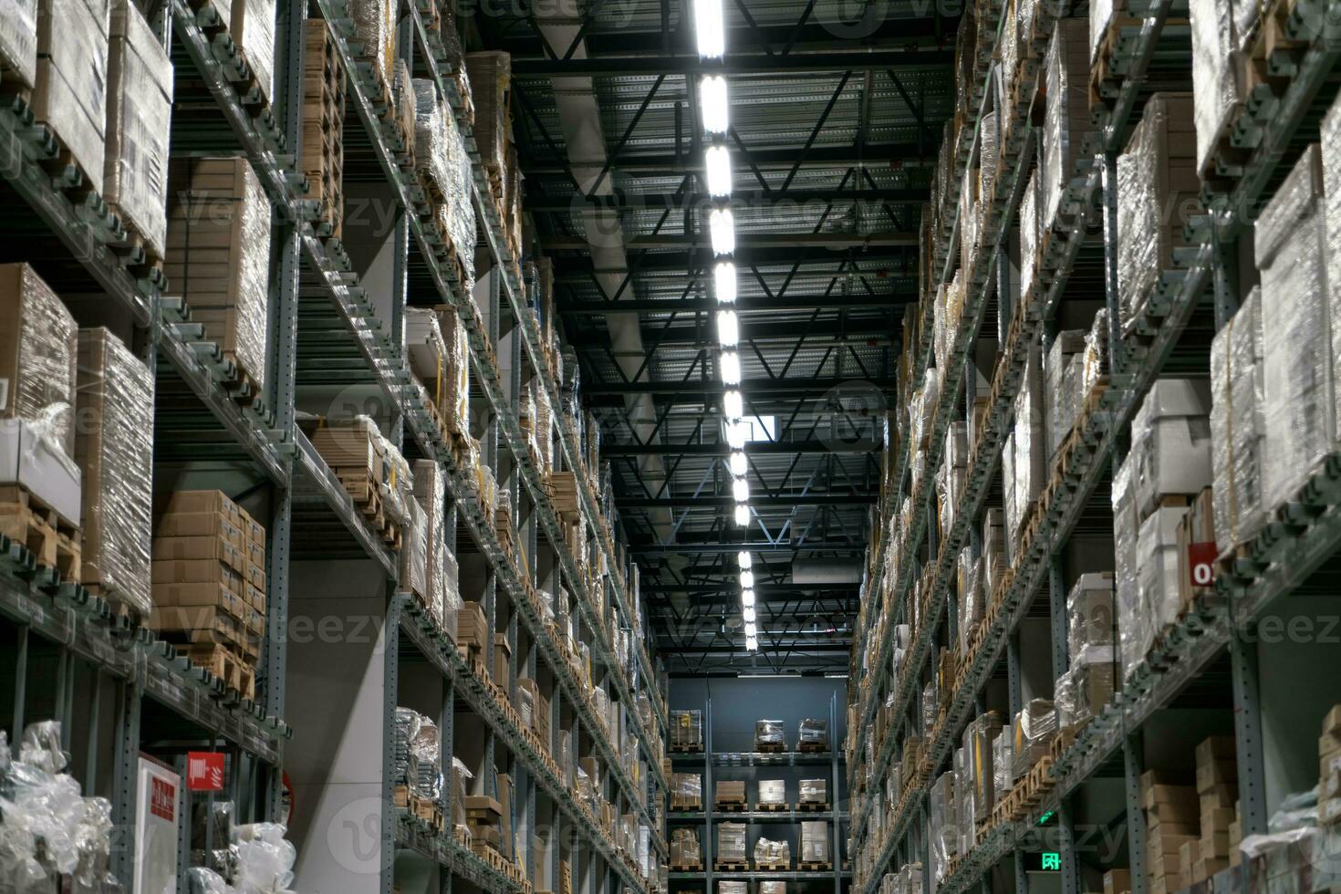 The warehouse full of goods, boxes and shelves photo