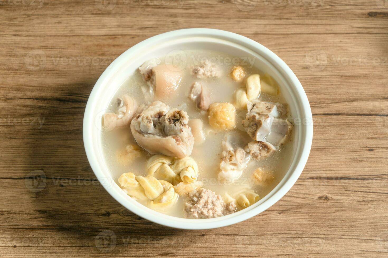 trotter soup with wooden background photo