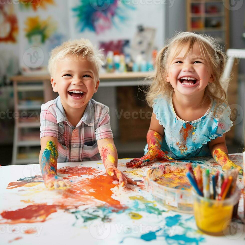 Cute children laughing together and having fun with paints. Painted in skin hands. Child portrait. Creative concept. Close up photo