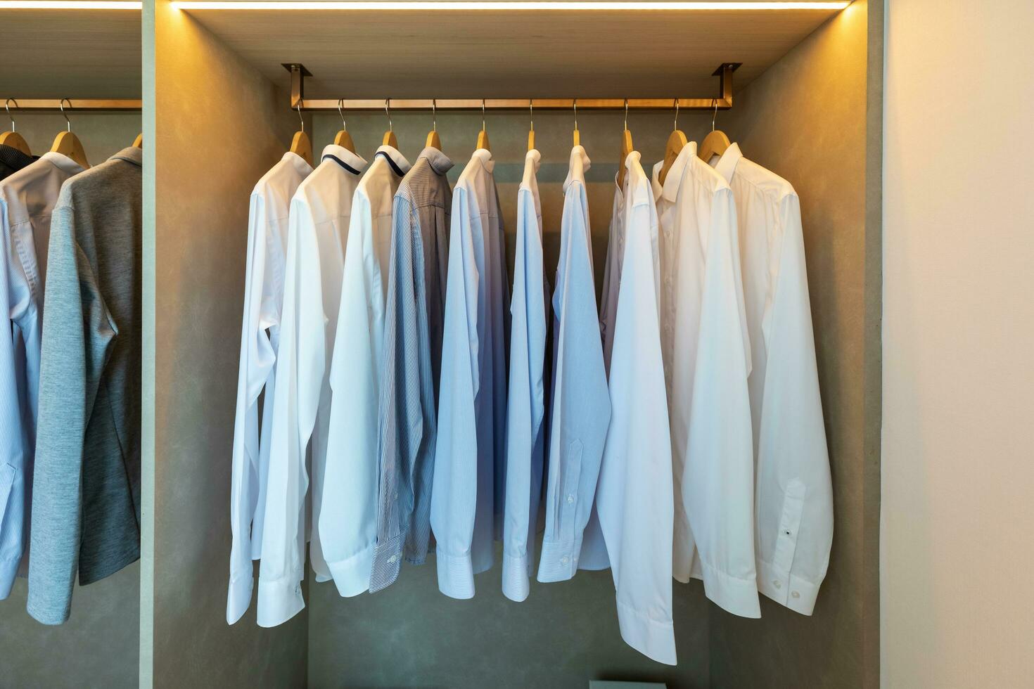 wardrobe with clothes hanging on rail photo
