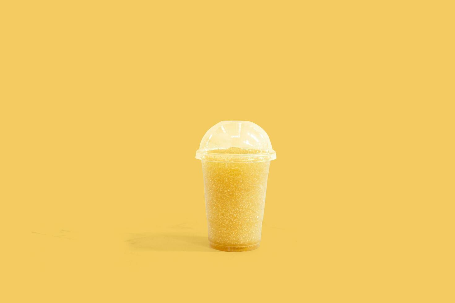 Fresh chrysanthemum smoothie in plastic cups take away on background, Fruit drink for healthy concept photo