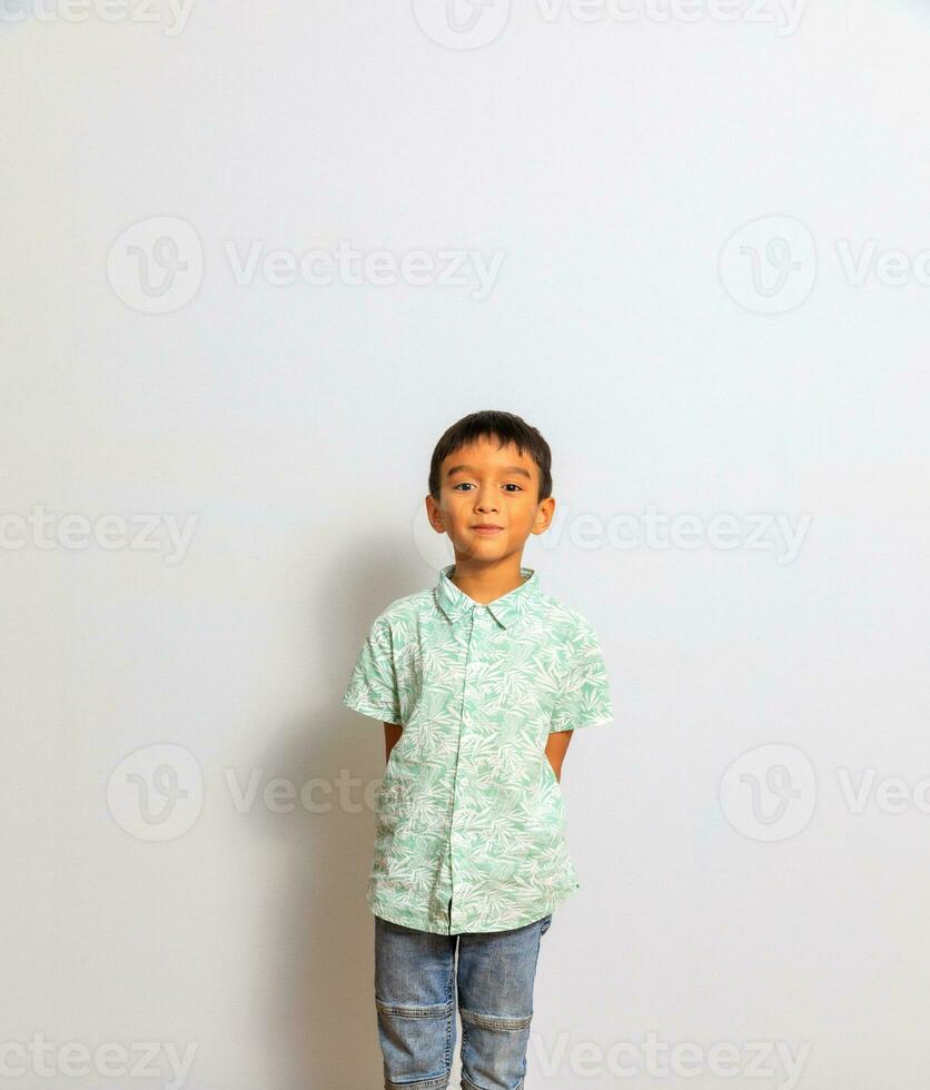 Cute little boy in casual outfit on background photo