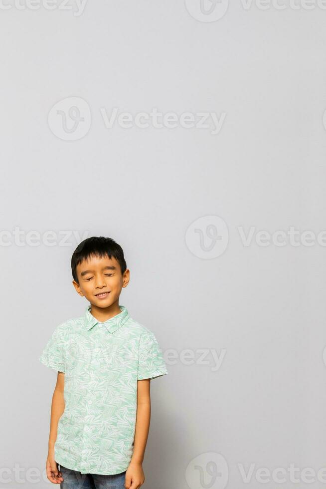 Cute little boy in casual outfit on background photo