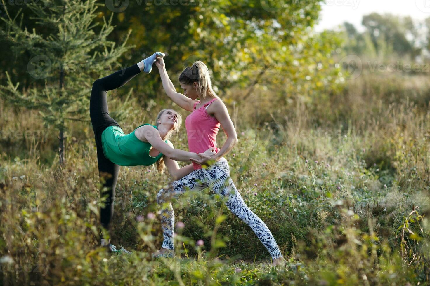 Two beautiful gymnasts or dancers working out photo