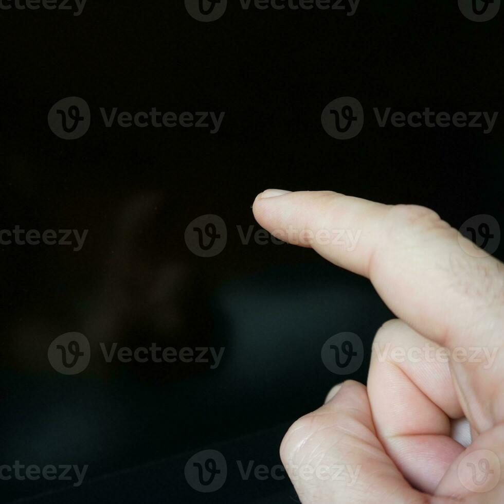 index finger pointing at digital screen to turn on the screen photo