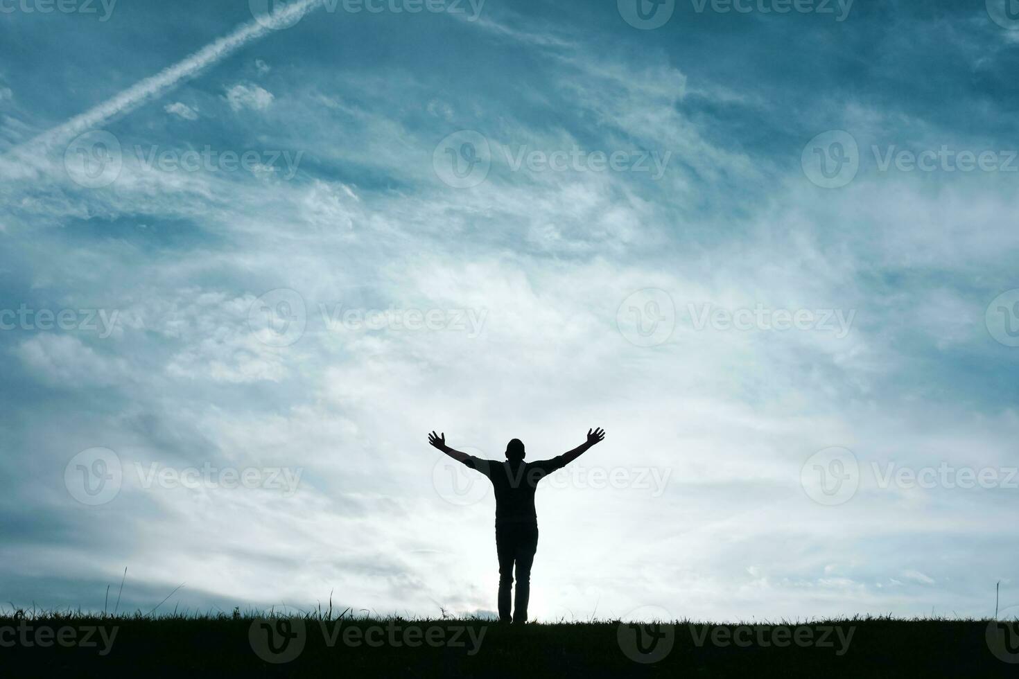 man silhouette feeling free among clouds in the mountain photo