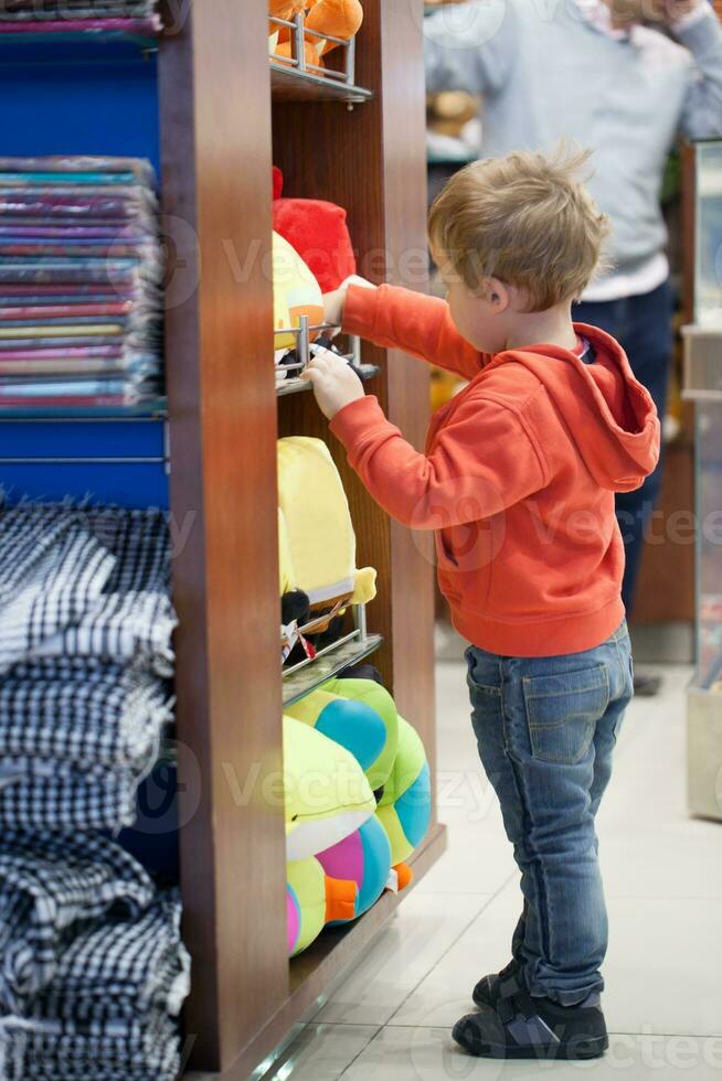 Cute little boy shopping for a beach accessories photo