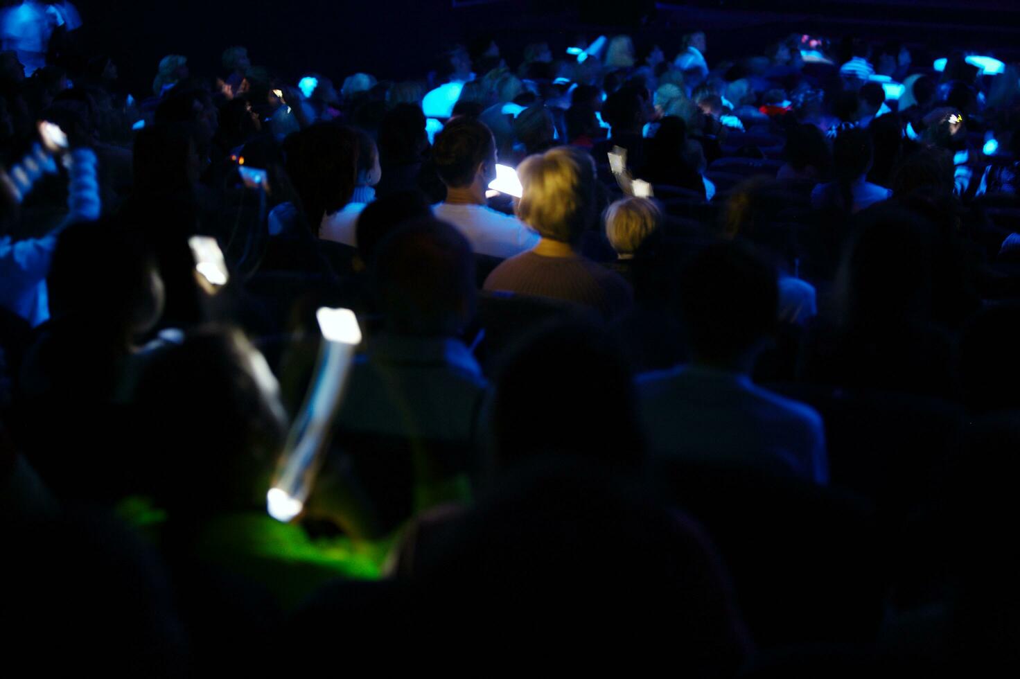 People recording a show with their smartphones photo