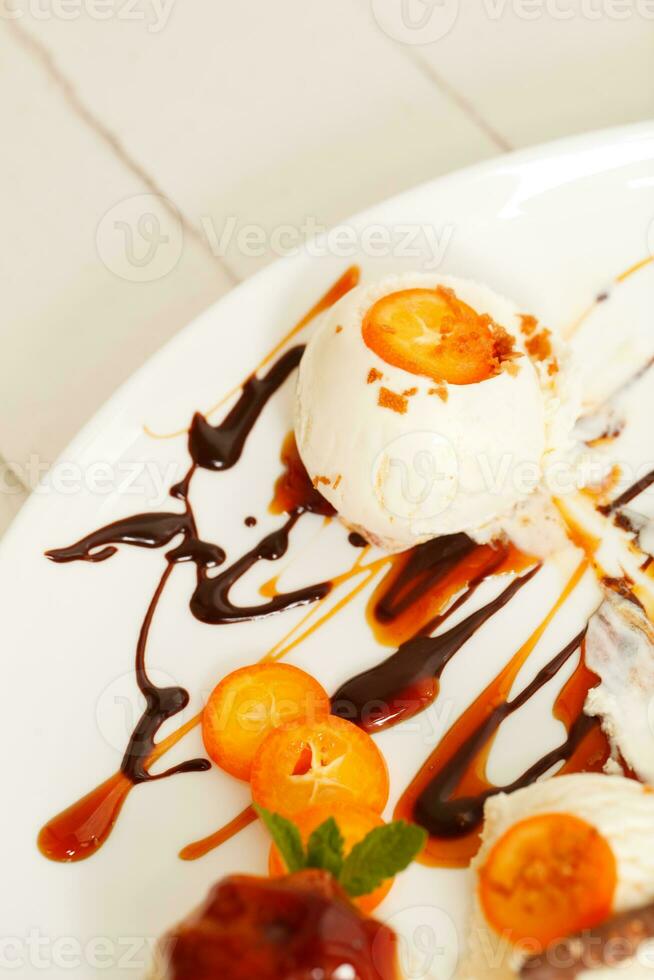 Vanilla ice cream with sliced kumquats photo
