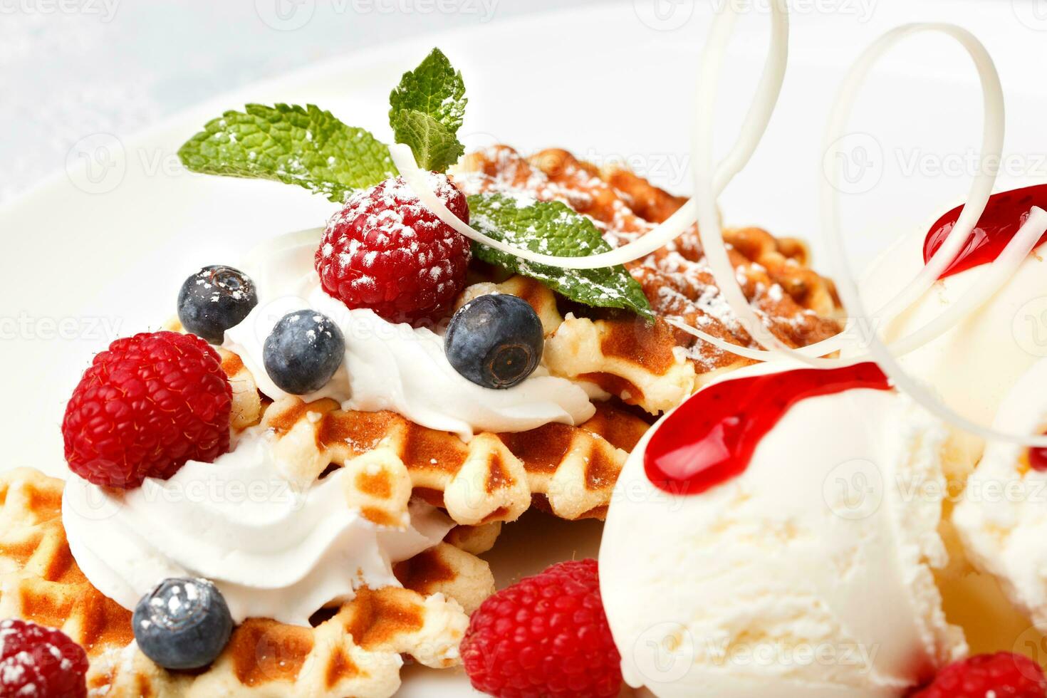 Waffle with vanilla ice cream and fresh berries photo