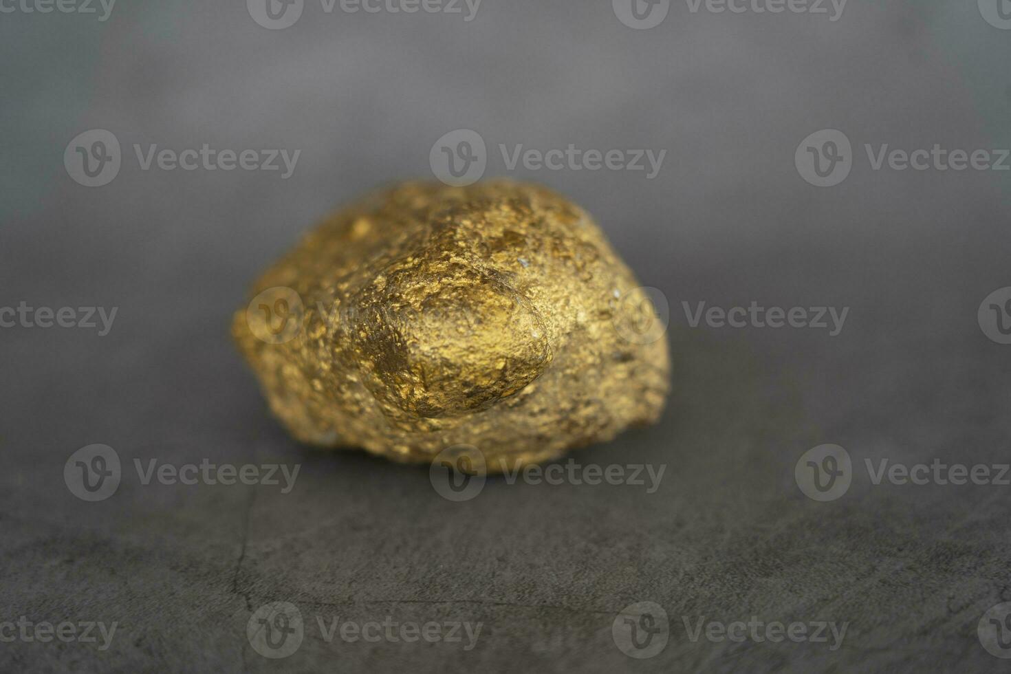 The pure piece of Raw Gold Nugget digger from Metal Mine. photo