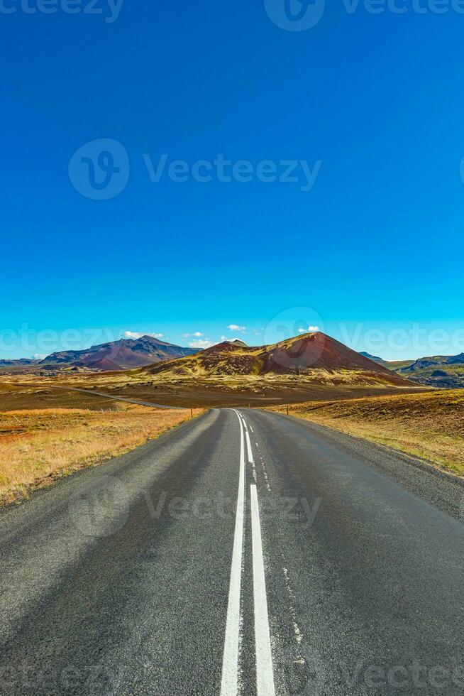 Cover page with a paved road and Icelandic colorful and wild landscape with fjords and sea at summer time, West Iceland photo