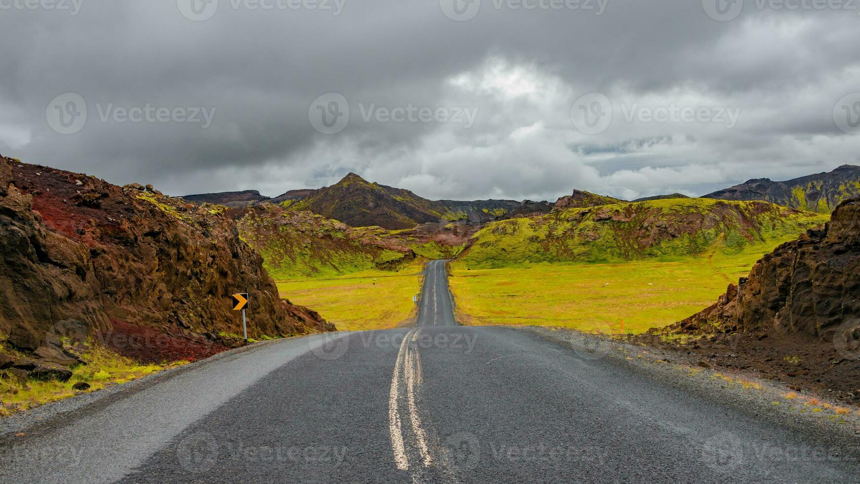 Panoramic over a paved road and dramatic Icelandic colorful and wild landscape at summer time, Iceland photo