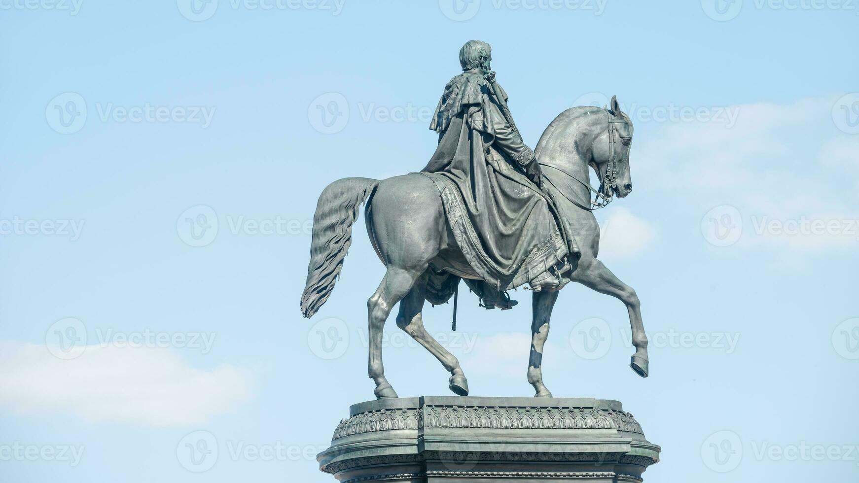 Dresden, Saxony, Germany - Statue of King Johann near Cathedral of Holy Trinity and State Opera. Cityscape over historical and touristic downtown at Spring sunny day photo