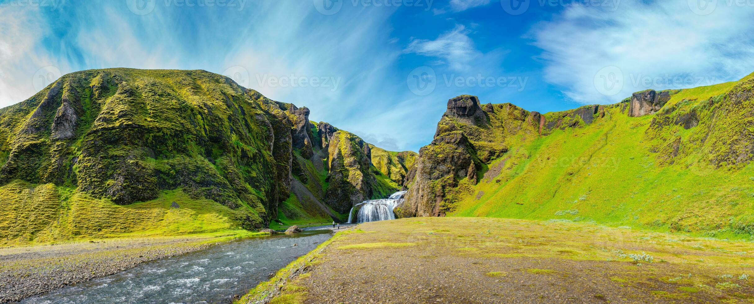 Panoramic over wonderful waterfall Stjornarfoss at blue sky and sunny day in South Iceland photo