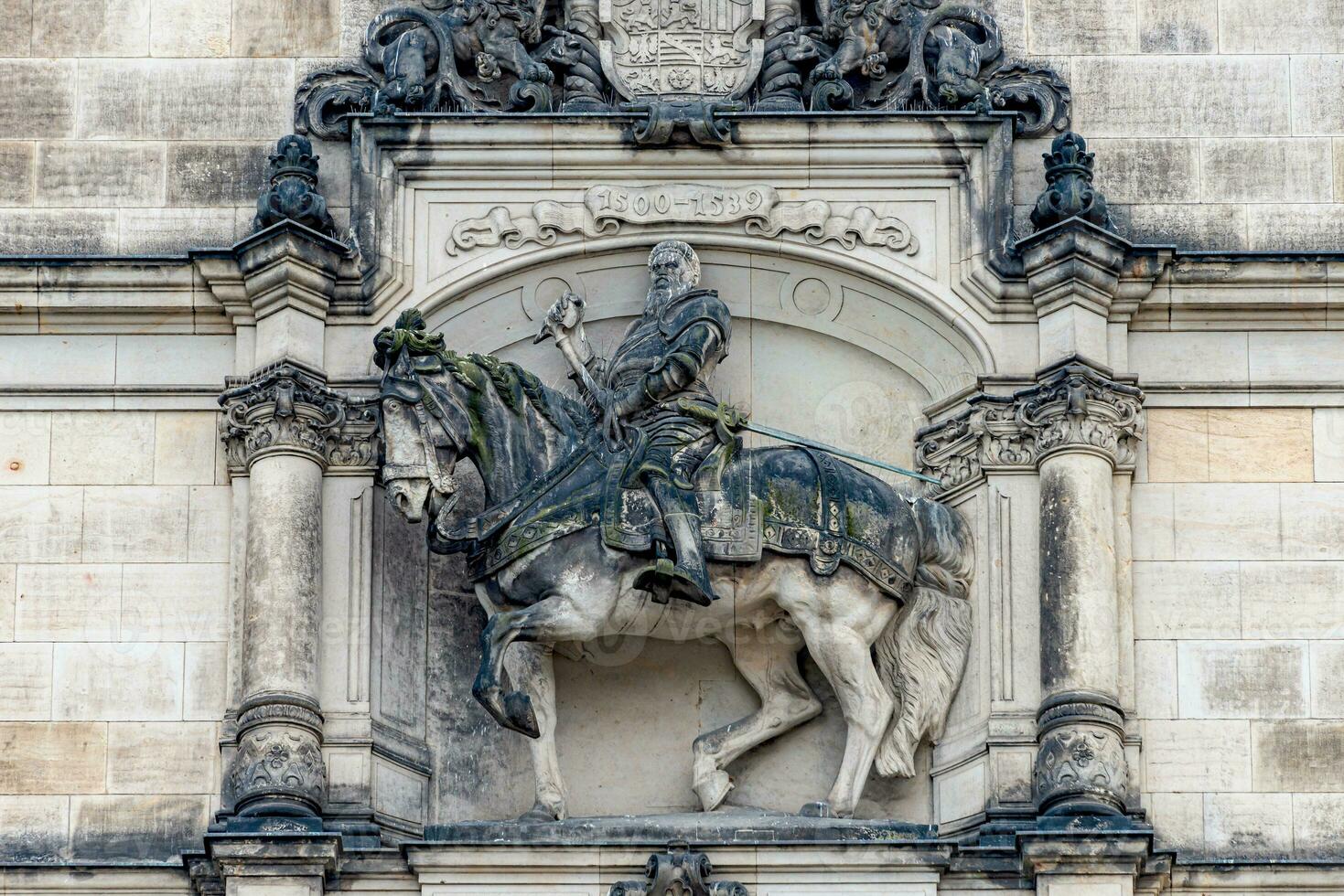 Dresden, Germany - Ancient sculpture of scary, fearful and heavy armed gatekeeper, medieval warrior, knight at horse in historical downtown, details, closeup. Authentic European old architecture. photo