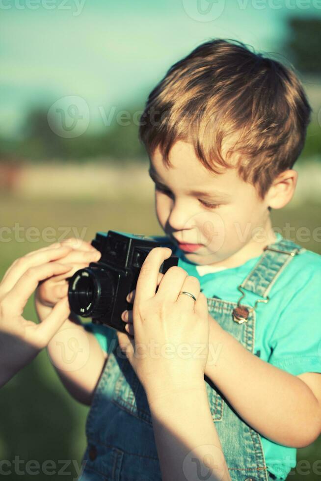 Mother helping her son to make his first photos