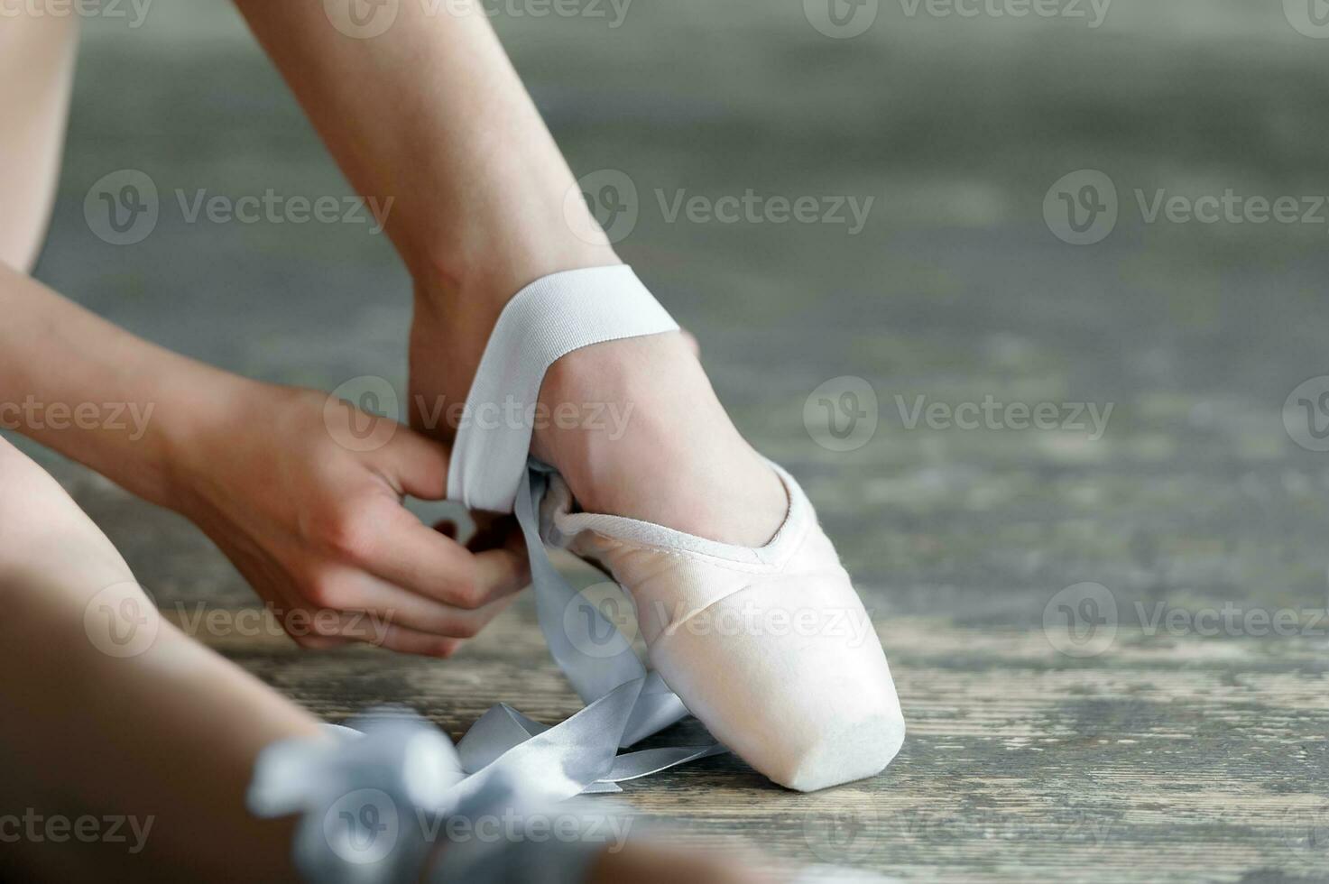 Taking off the ballet shoes after rehearsal or performance photo