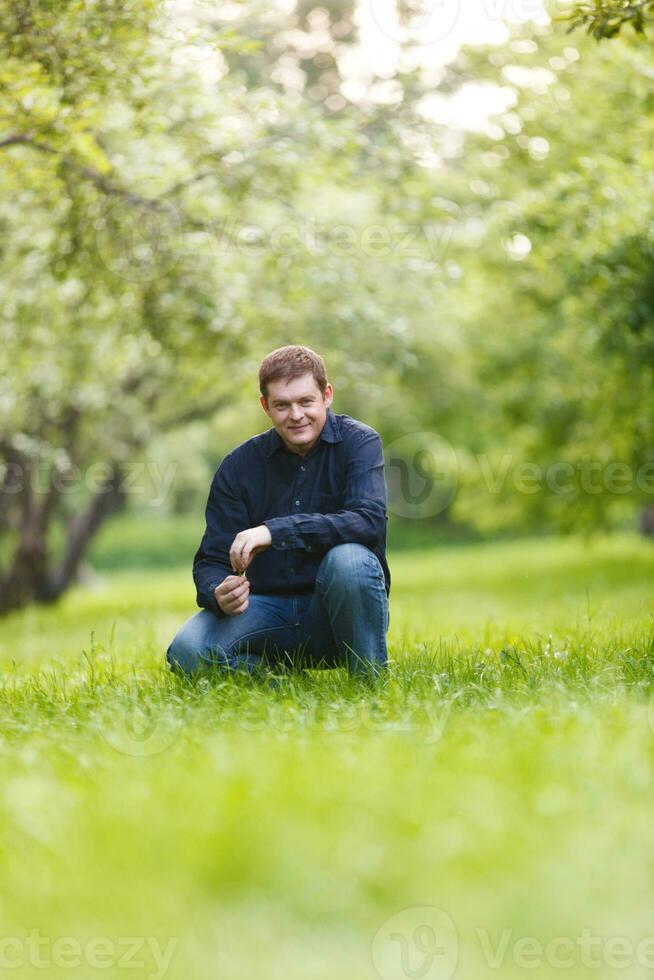 Middle-aged man resting in the city park photo