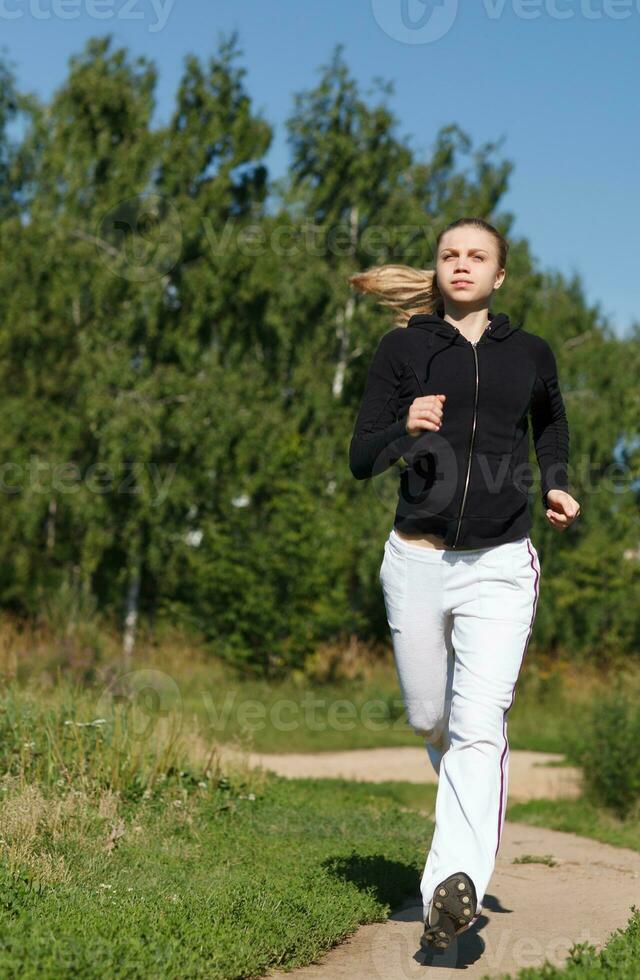 Girl running in the park. Wide shot photo