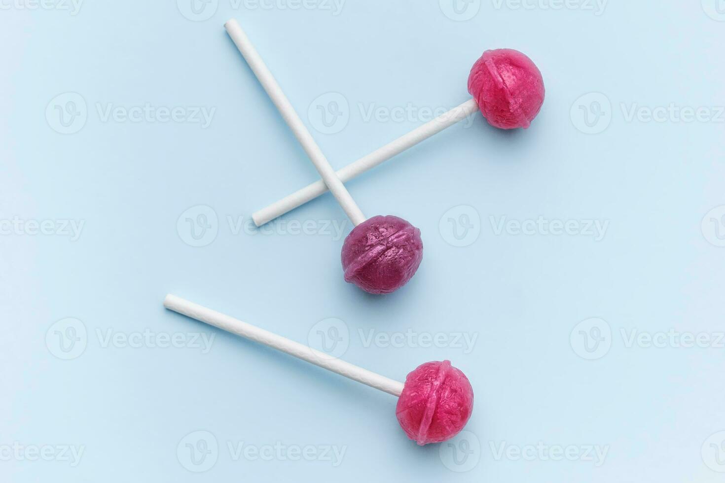 Sweet lollipops on blue background photo