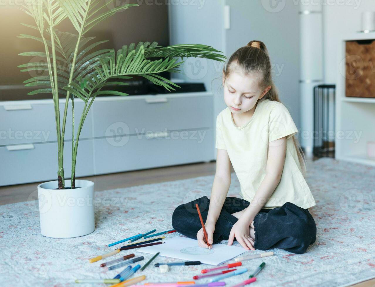 Child girl drawing with colorful pencils photo