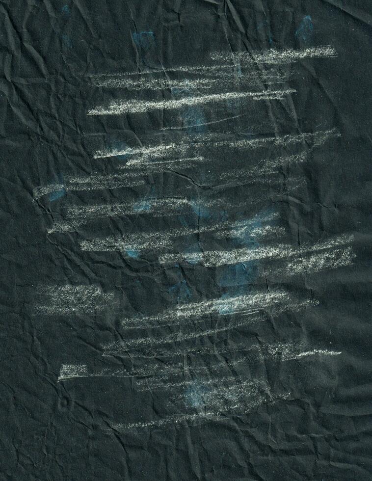 Creased black paper texture background. Crumpled and wrinkled grunge backdrop. photo