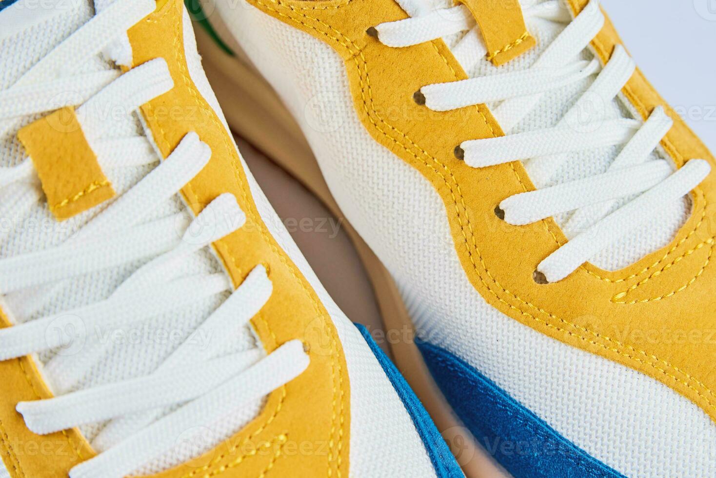 Casual sneakers on yellow background, creative minimalism photo