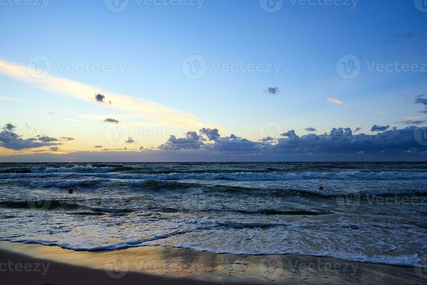 Sunset sky over sea or ocean with sand beach photo