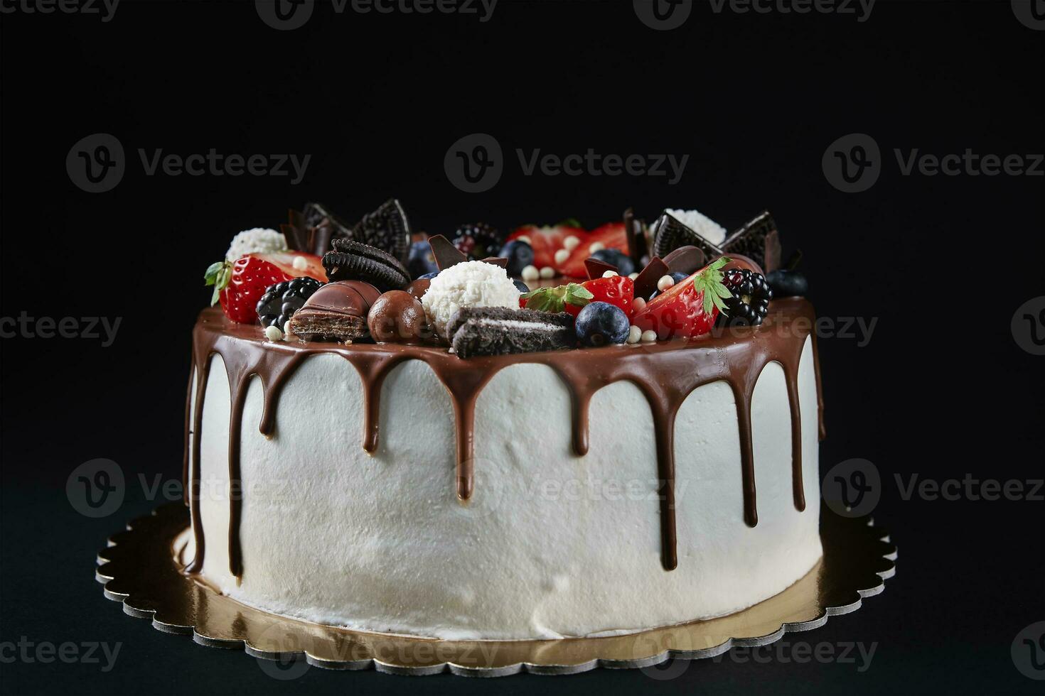 Cake decorated with strawberry and chocolate on dark background photo