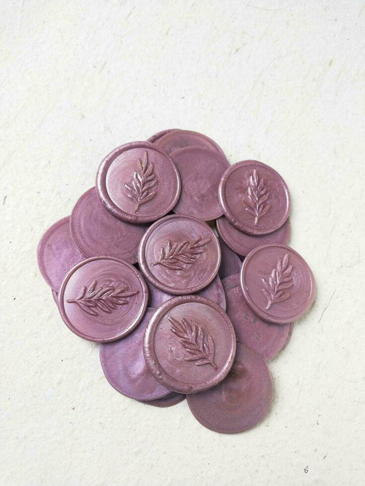 colorful wax coin made from wax sealing stamp for vintage look for letter or wedding invitation photo