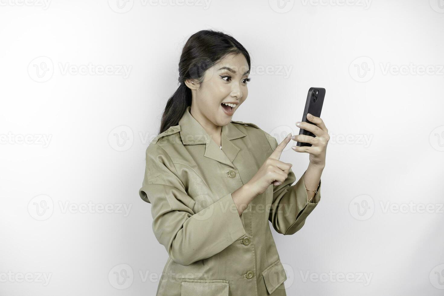 Smiling government worker woman holding her smartphone. PNS wearing khaki uniform. photo