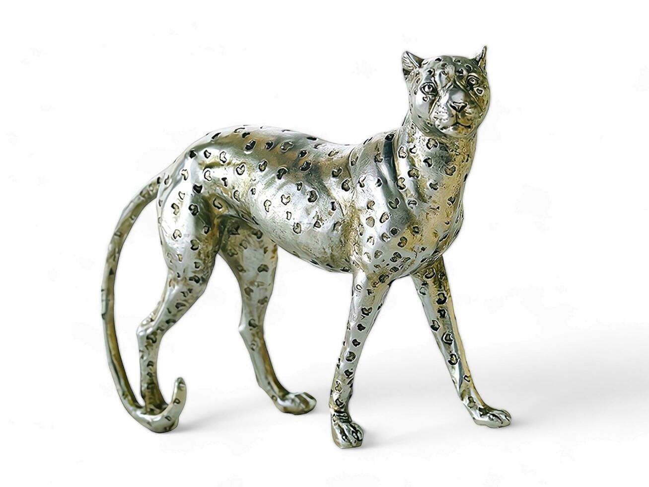 a seated leopard statue in silver on a white background photo