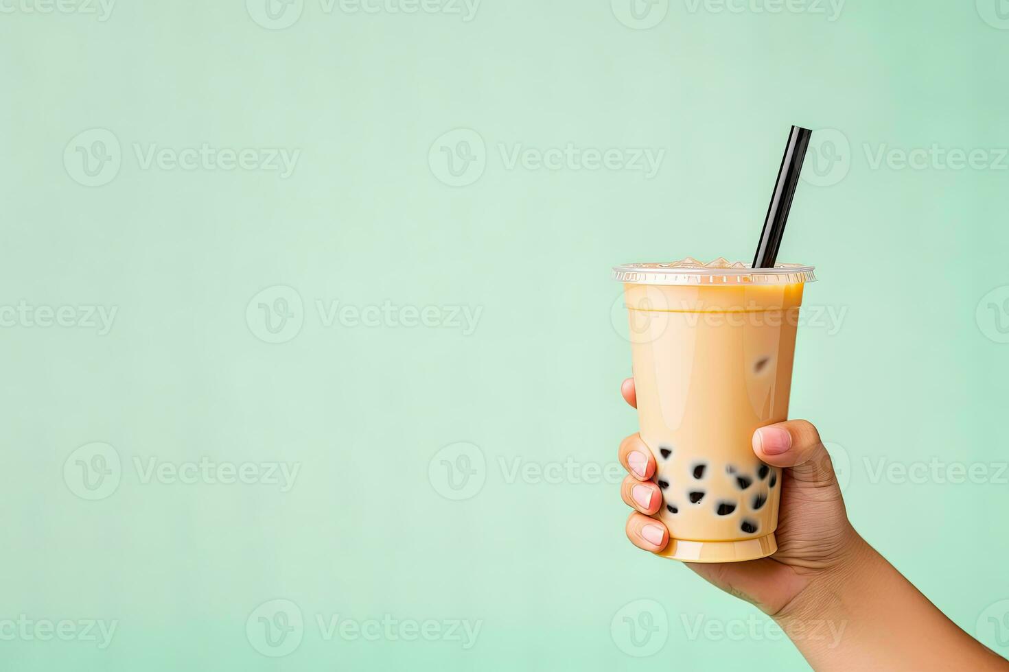 A hand holding takeaway plastic cup of delicious iced bubble milk tea and black pearls with copy space. ai generated photo