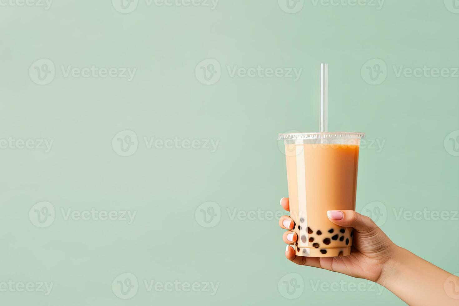 A hand holding takeaway plastic cup of delicious iced bubble milk tea and black pearls with copy space. ai generated photo