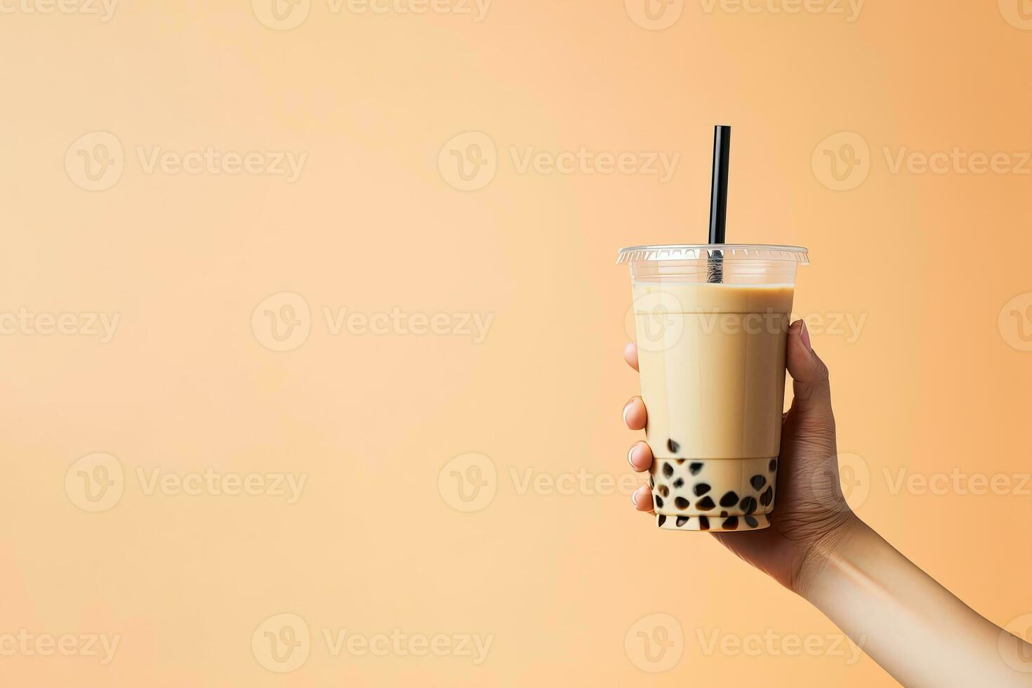 A hand holding takeaway plastic cup of delicious iced bubble milk tea and black pearls with copy space. ai generated photo