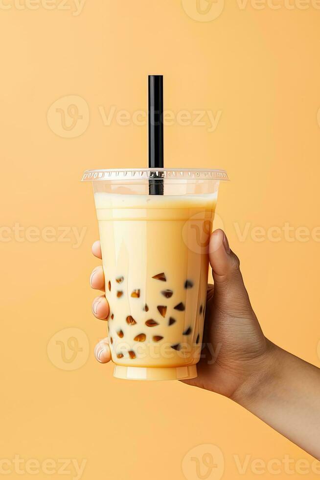 A hand holding takeaway plastic cup of delicious iced bubble milk tea and black pearls. ai generated photo