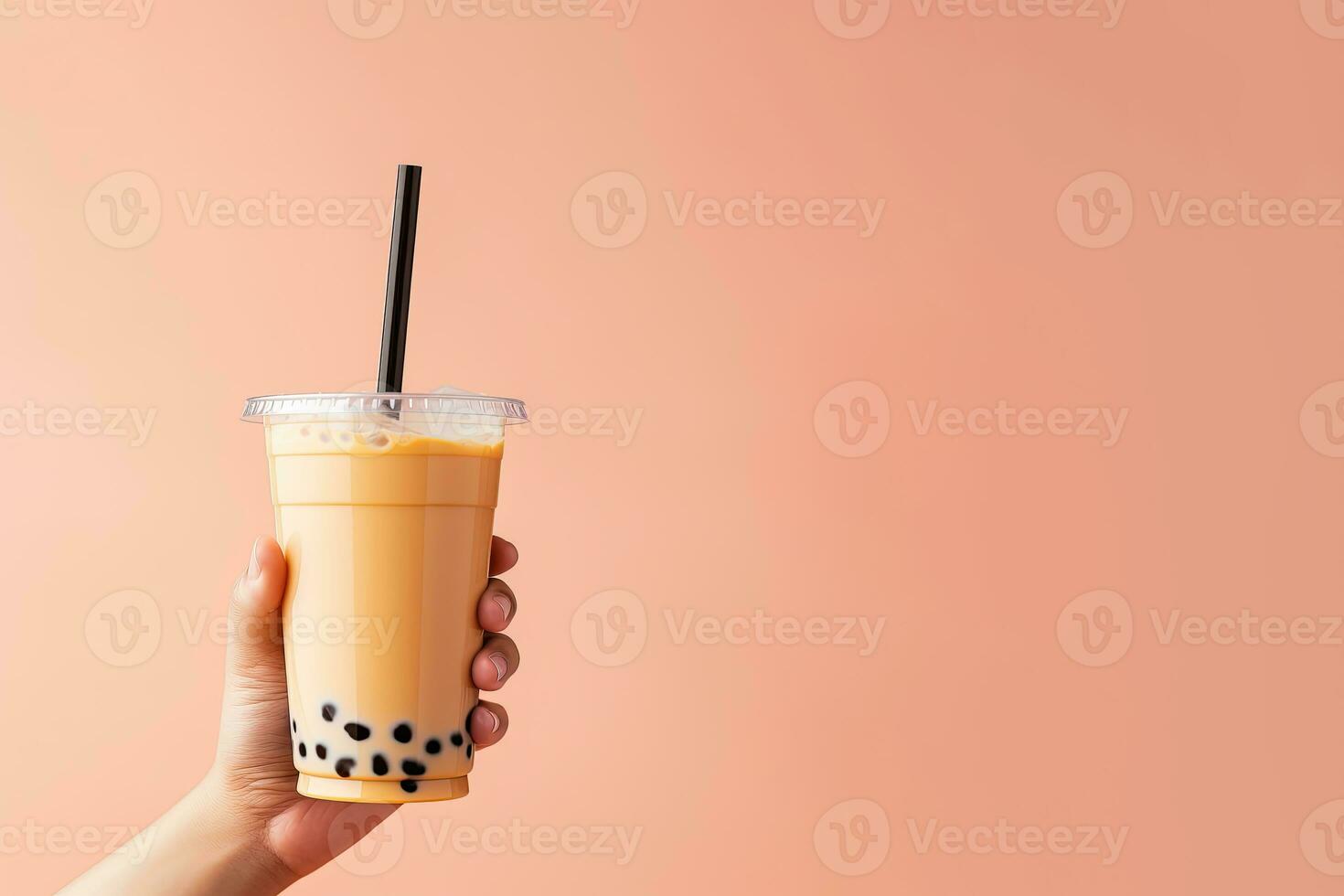 A hand holding takeaway plastic cup of delicious iced bubble milk tea and black pearls with copy space. ai generated photo