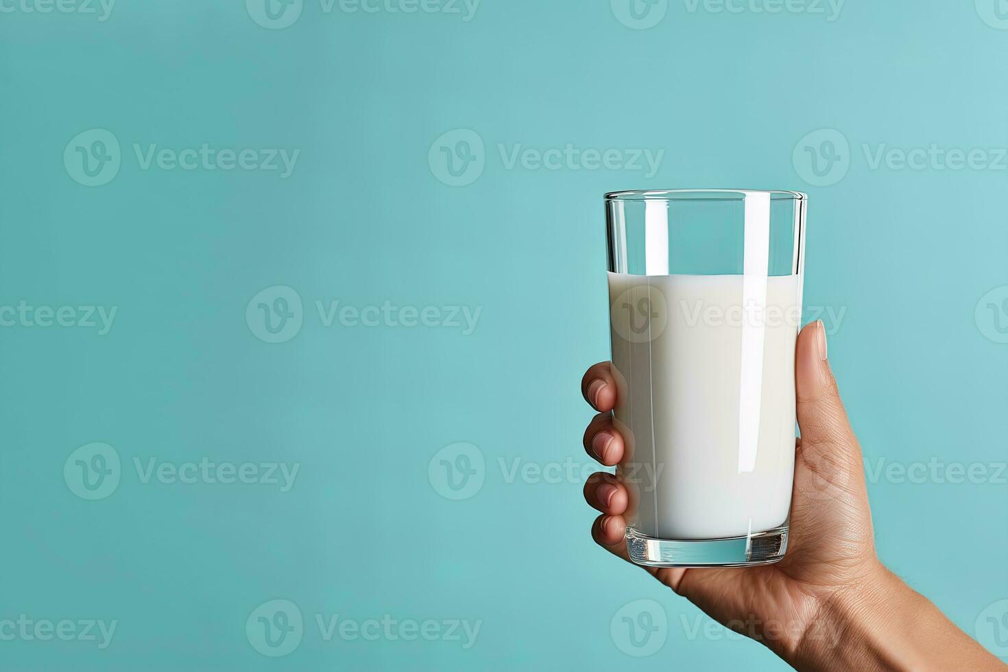 Hand holding a glass of fresh milk with copy space. ai generated photo