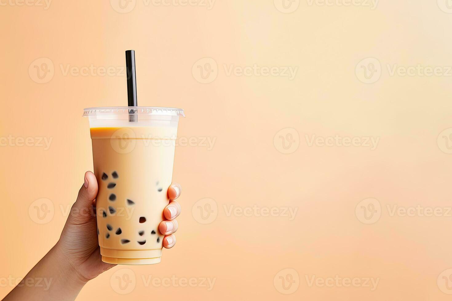 A hand holding takeaway plastic cup of delicious iced bubble milk tea and black pearls with copy space. ai generated photo