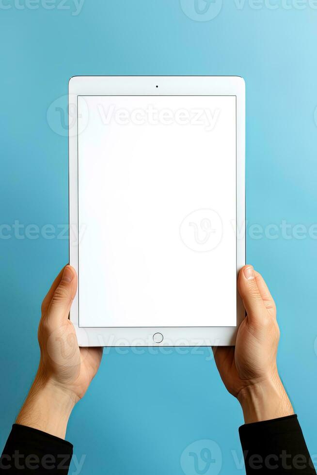 Hand holding tablet with mockup blank screen isolated on blue background. ai generated photo